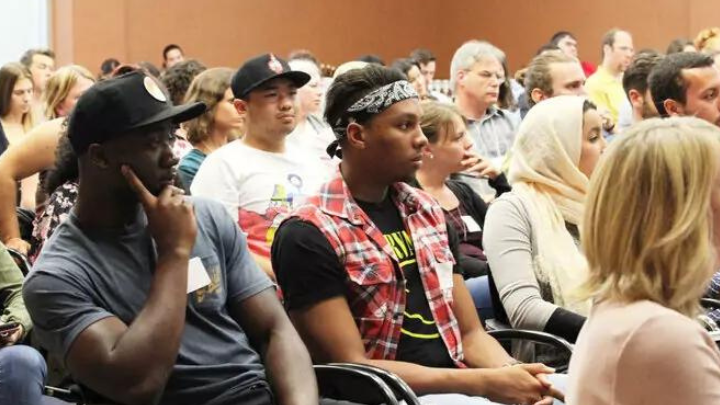 Large group of students sitting and listening to a lecture.